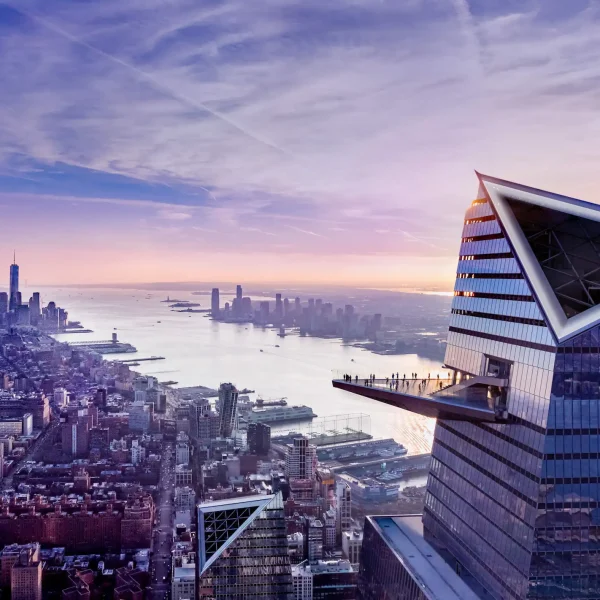 Aerial sunset view of New York City featuring the Edge observation deck at Hudson Yards with people enjoying panoramic skyline and harbor views
