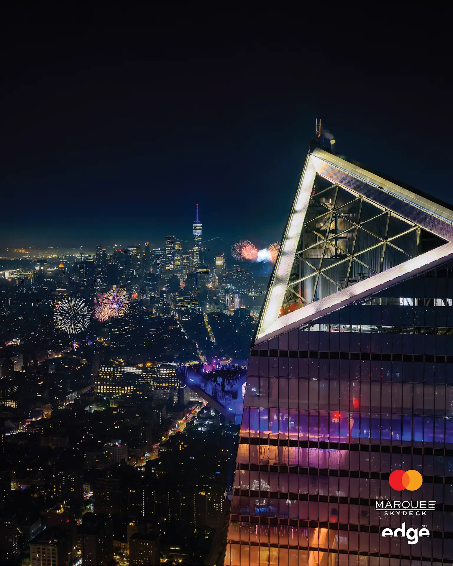 Fireworks over the NYC skyline viewed from Edge’s glass sky deck at night