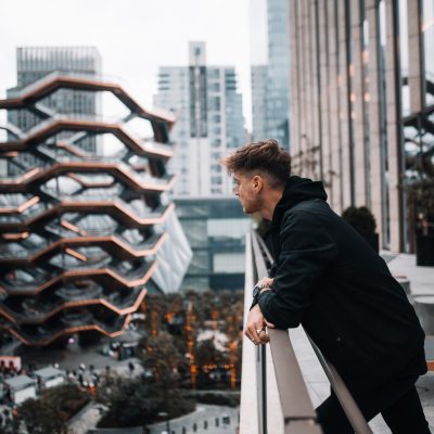 Man overlooking the city from a balcony near Hudson Yards in New York